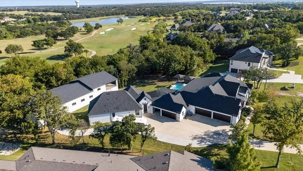 an aerial view of a house with garden space and lake view