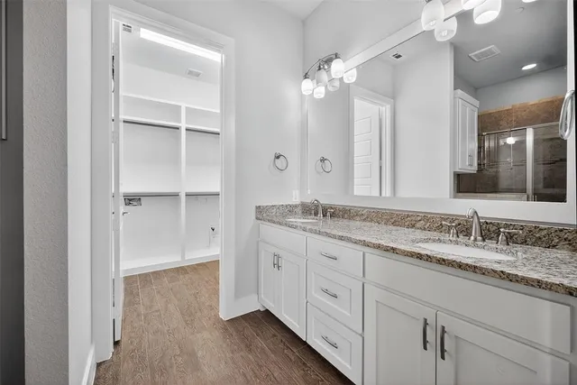 a bathroom with a granite countertop sink double and mirror