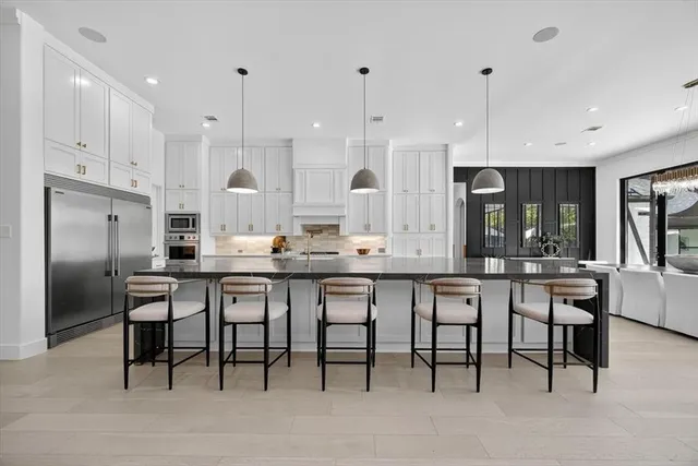 a large kitchen with a table and chairs