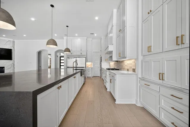 a kitchen with counter top space a sink stainless steel appliances and cabinets
