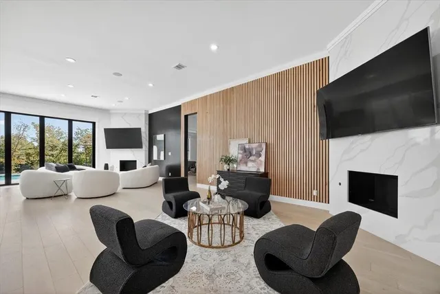 a living room with fireplace furniture and a flat screen tv