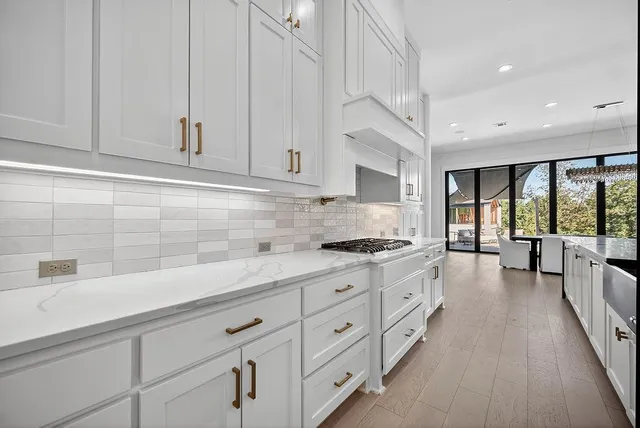 a kitchen with granite countertop white cabinets and white appliances