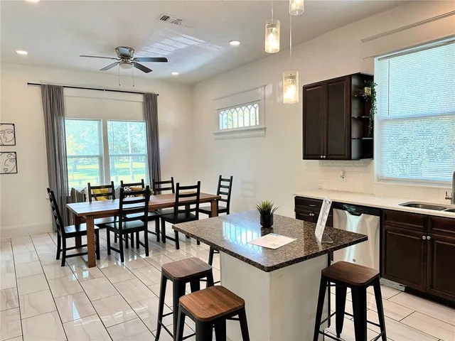 a view of a dining room with furniture and a chandelier