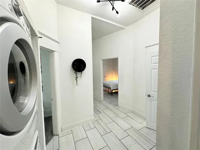 a view of a hallway with washer and dryer