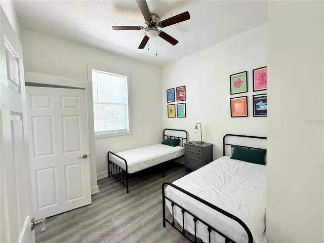 a bedroom with two beds and a desk