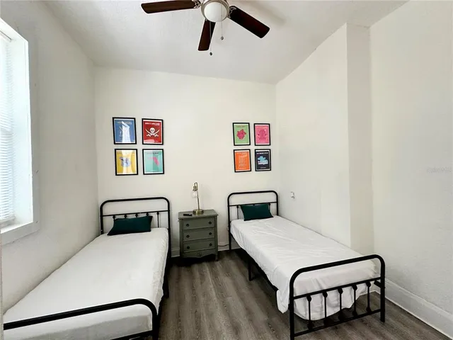 a room with two bed and a desk