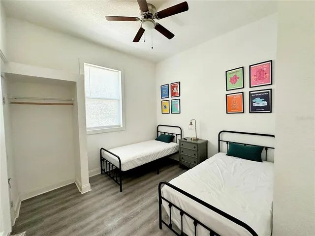 a bedroom with two beds and a window