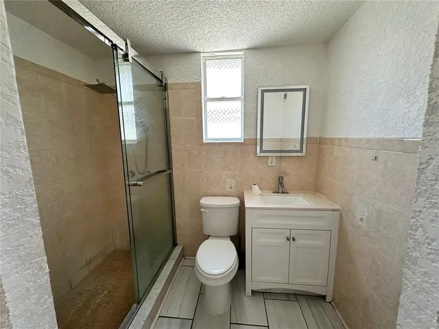 a bedroom with a bed and a mirror