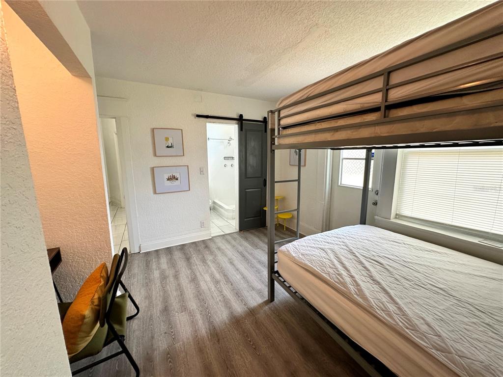 3105 West Spruce Street Tampa, FL 33607 - Photo 38 of 53 a bedroom with a bed and wooden floor