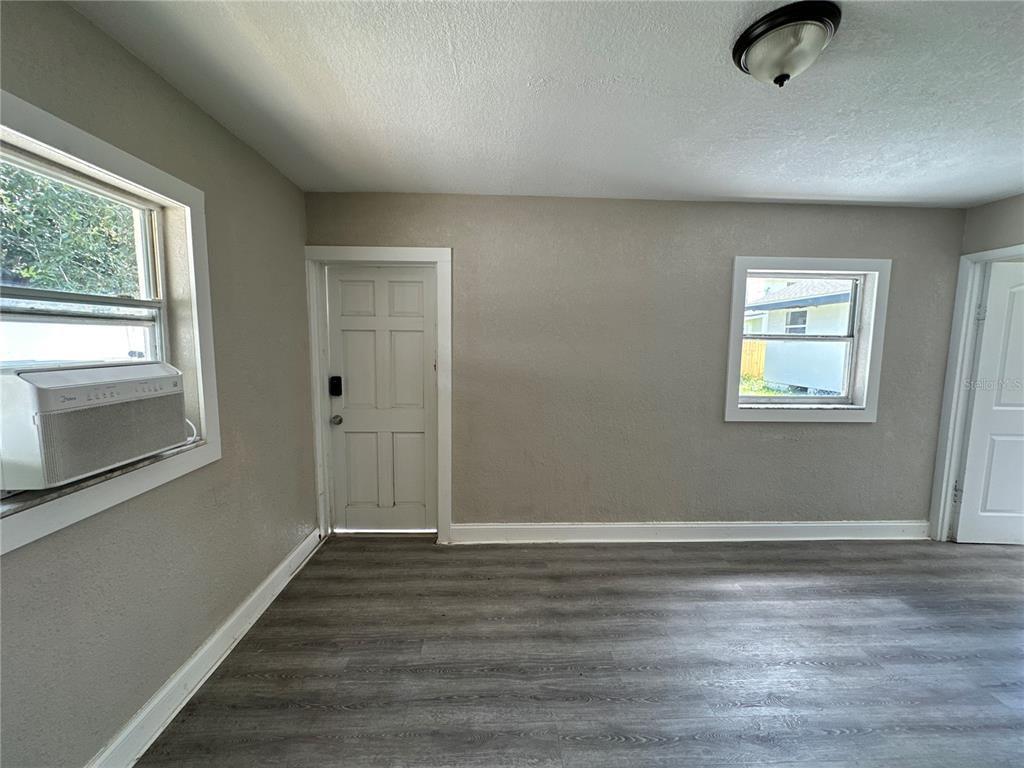 3105 West Spruce Street Tampa, FL 33607 - Photo 44 of 53 wooden floor in an empty room with a window