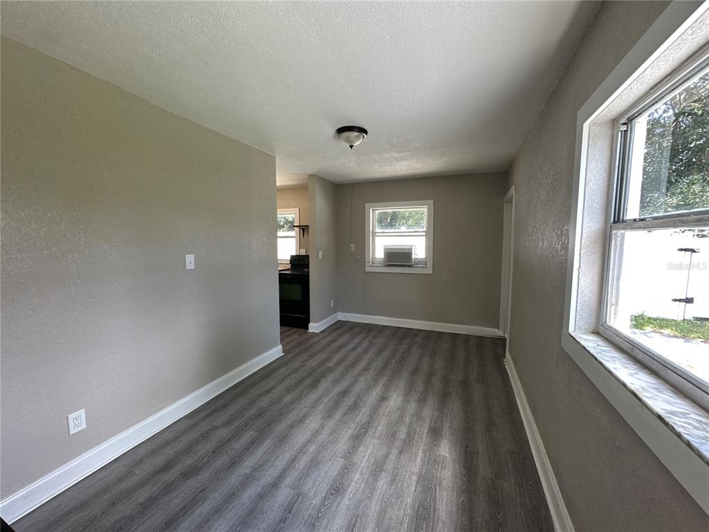 3105 West Spruce Street Tampa, FL 33607 - Photo 46 of 53 a view of an empty room with wooden floor and a window