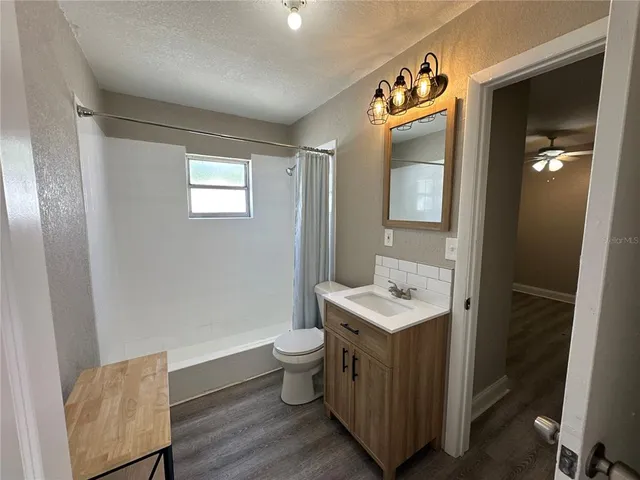 a view of room with window and wooden floor