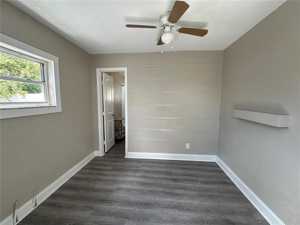 3105 West Spruce Street Tampa, FL 33607 - Photo 52 of 53 an empty room with wooden floor closet and windows