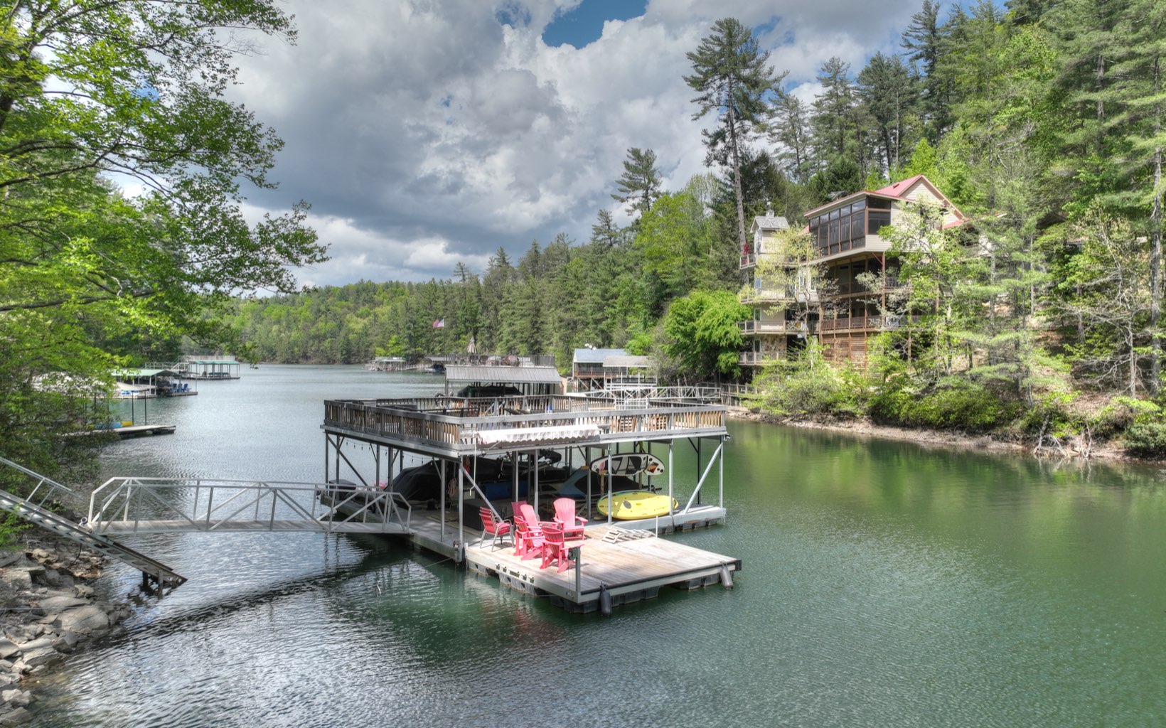 986 Shady Falls Road Blue Ridge, GA 30513 - Photo 3 of 68 a view of a lake with a table and chairs