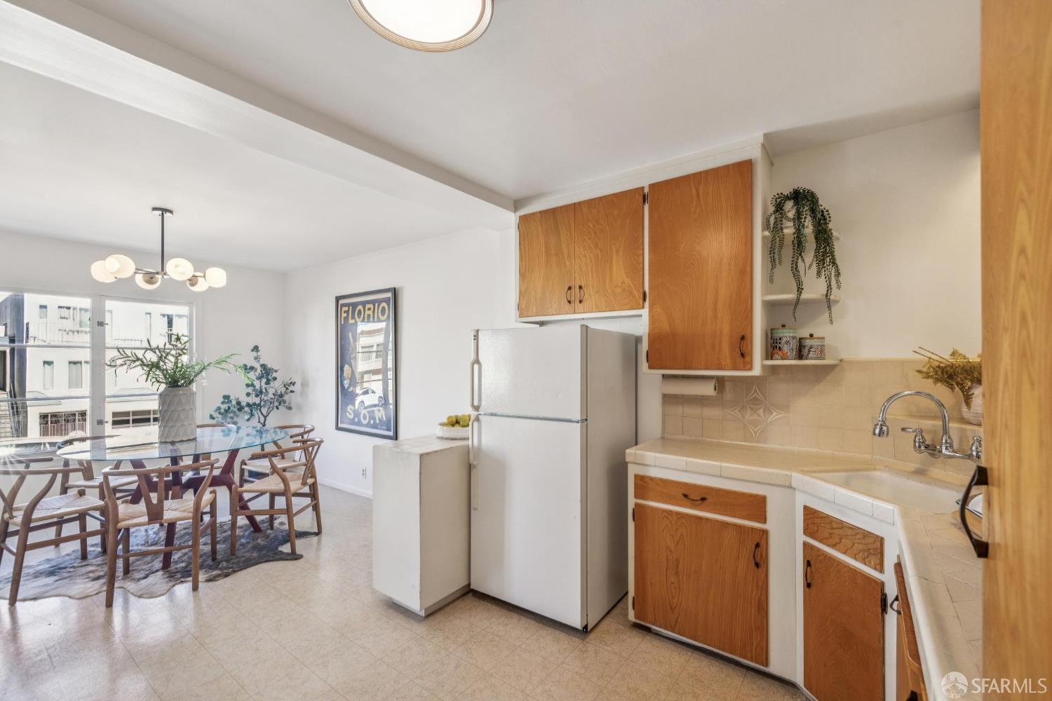 2015-2017 Judah Street San Francisco, CA 94122 - Photo 12 of 58 a kitchen with appliances a refrigerator and a dining table