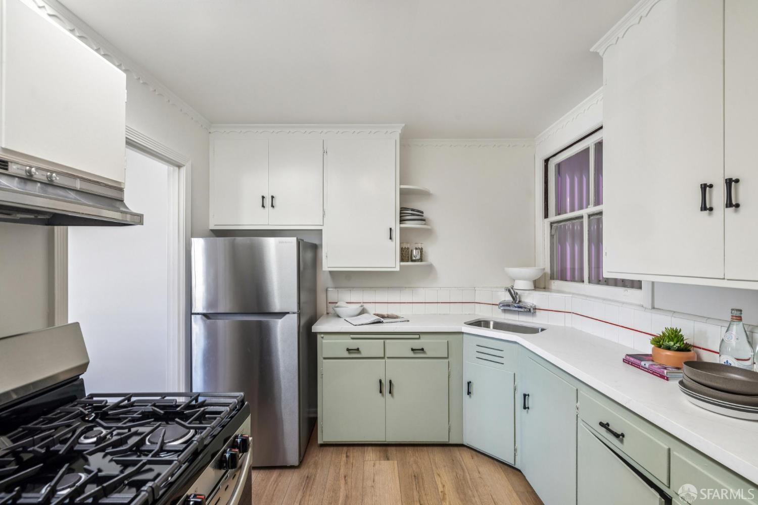 2015-2017 Judah Street San Francisco, CA 94122 - Photo 39 of 58 a kitchen with a stove sink and refrigerator