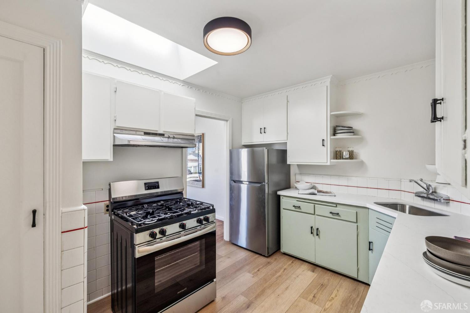 2015-2017 Judah Street San Francisco, CA 94122 - Photo 41 of 58 a kitchen with a stove a sink and a refrigerator