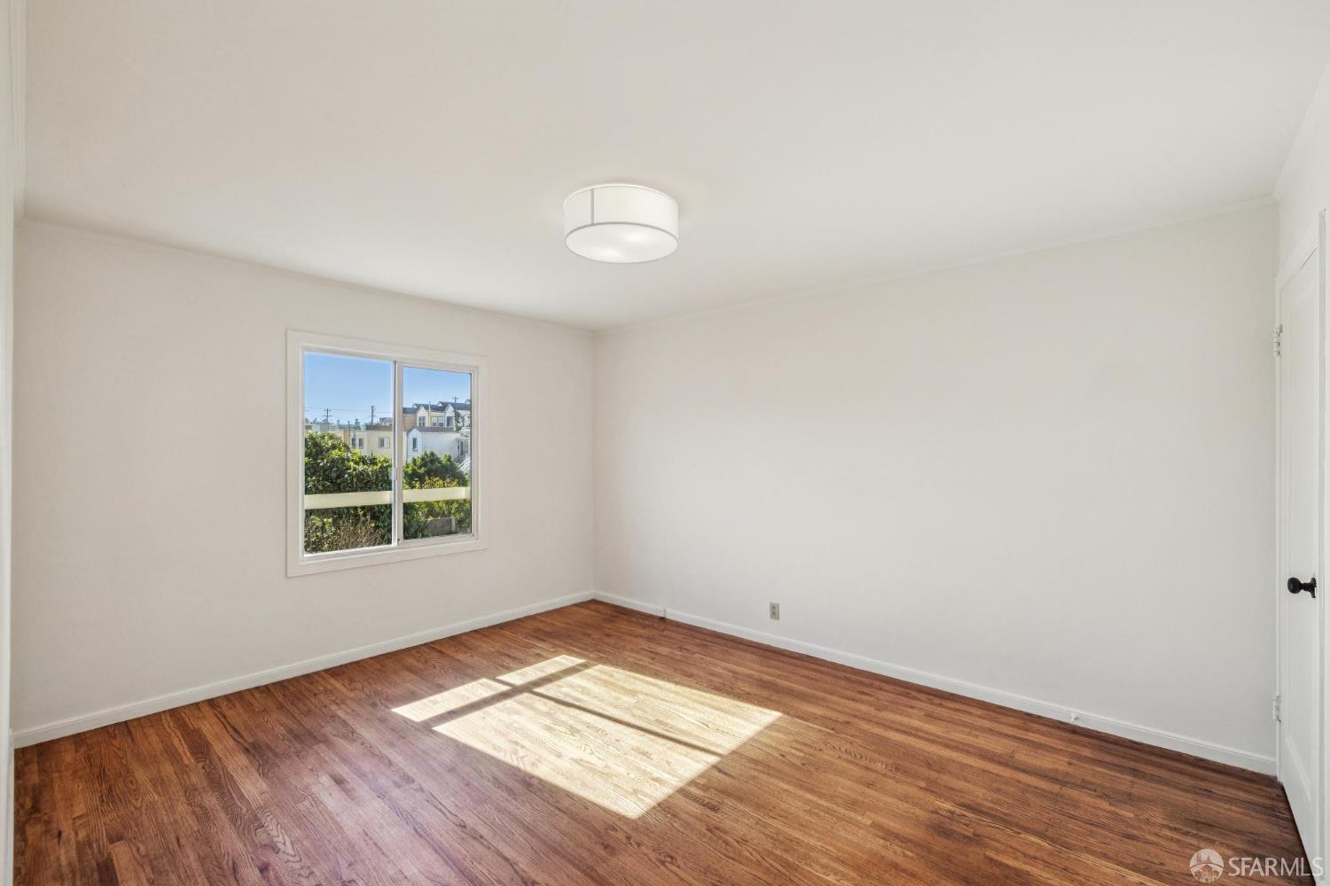2015-2017 Judah Street San Francisco, CA 94122 - Photo 44 of 58 an empty room with wooden floor and windows