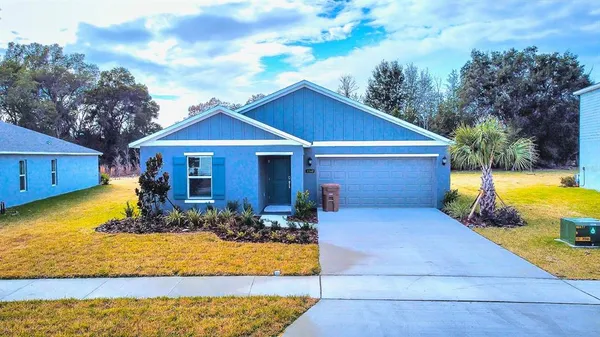 a front view of a house with swimming pool having outdoor seating