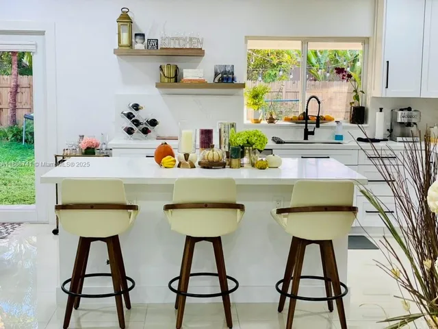 a dining room filled chandelier and wooden floor
