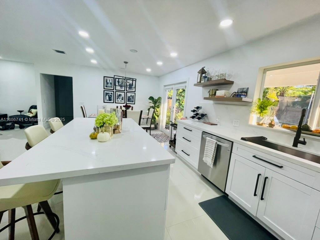 8410 Southwest 201st Street Cutler Bay, FL 33189 - Photo 15 of 33 a kitchen with stainless steel appliances a white table chairs and a refrigerator