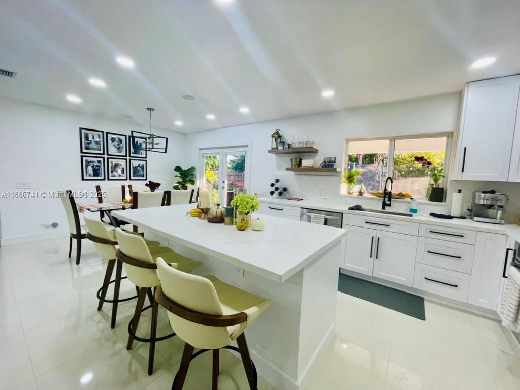 8410 Southwest 201st Street Cutler Bay, FL 33189 - Photo 16 of 33 a kitchen with a table chairs and a refrigerator