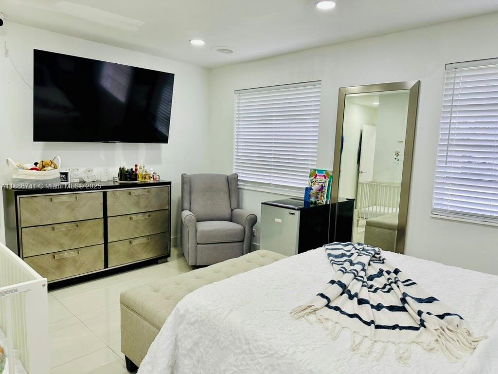 8410 Southwest 201st Street Cutler Bay, FL 33189 - Photo 17 of 33 a bedroom with a bed and flat screen tv