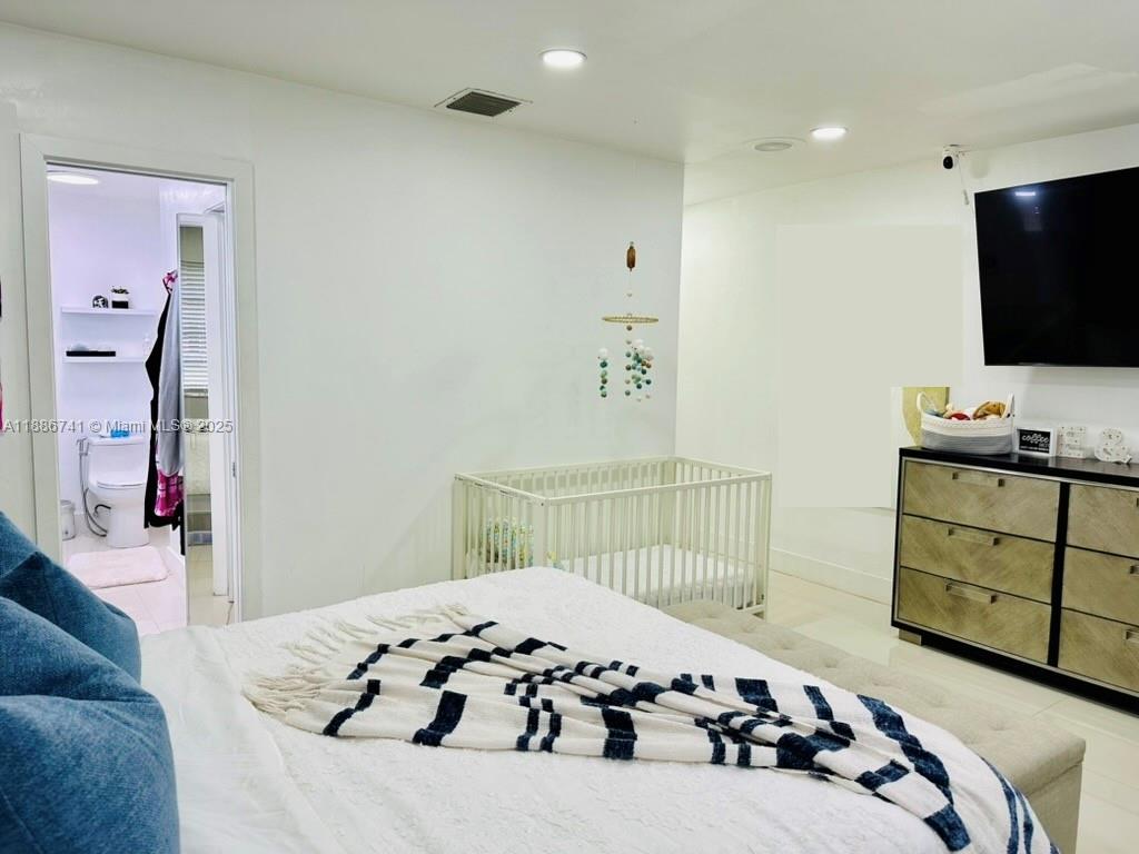 8410 Southwest 201st Street Cutler Bay, FL 33189 - Photo 19 of 33 a bedroom with a bed and flat screen tv