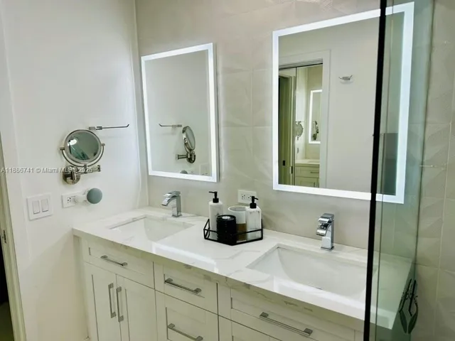 a bathroom with a double vanity sink and mirror