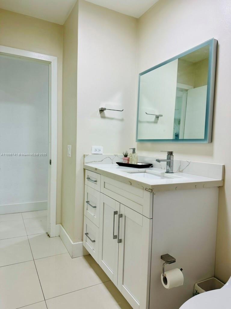 8410 Southwest 201st Street Cutler Bay, FL 33189 - Photo 22 of 33 a bathroom with a double vanity sink and mirror