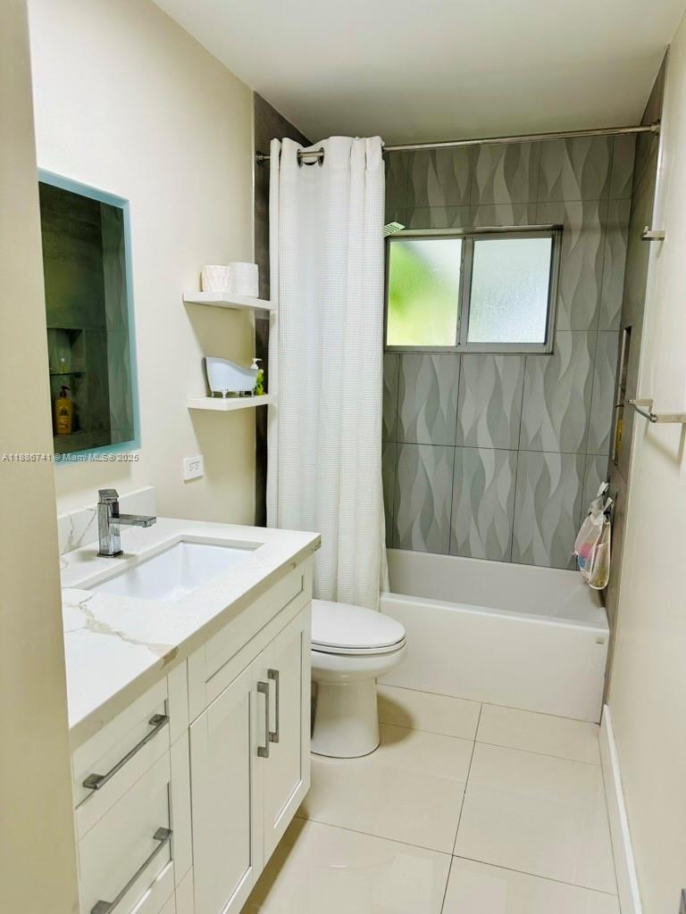 8410 Southwest 201st Street Cutler Bay, FL 33189 - Photo 23 of 33 a bathroom with a sink a toilet and shower