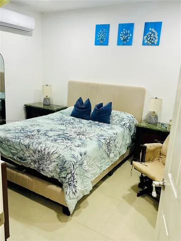 a living room with patio furniture and a floor to ceiling window