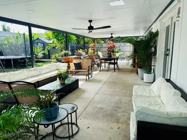 a view of a patio with a table and chairs