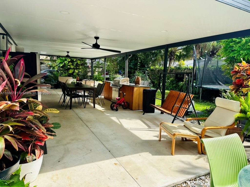 8410 Southwest 201st Street Cutler Bay, FL 33189 - Photo 30 of 33 a view of a patio with a table and chairs