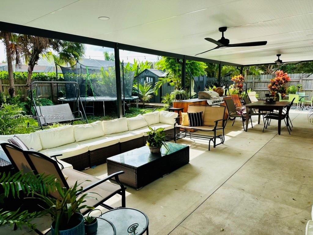 8410 Southwest 201st Street Cutler Bay, FL 33189 - Photo 32 of 33 a living room with patio furniture and a floor to ceiling window