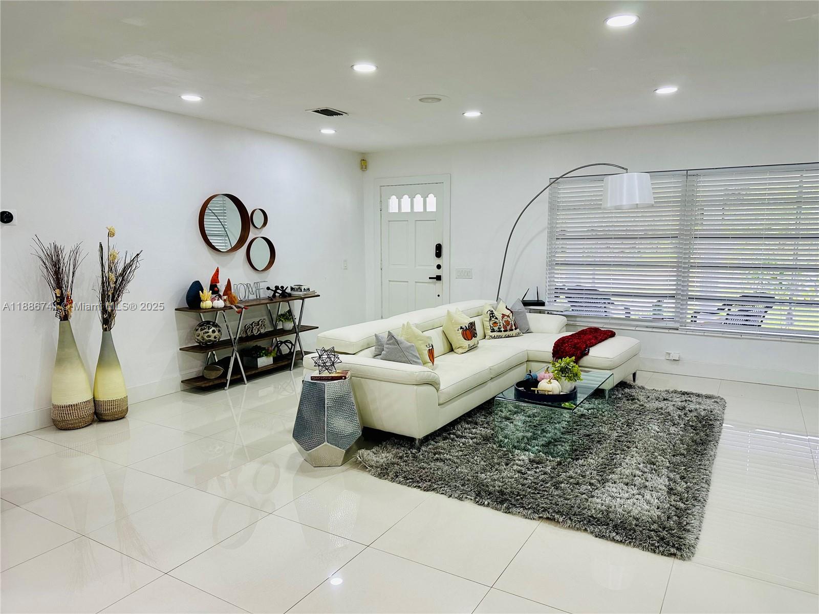 8410 Southwest 201st Street Cutler Bay, FL 33189 - Photo 8 of 33 a living room with furniture and a chandelier