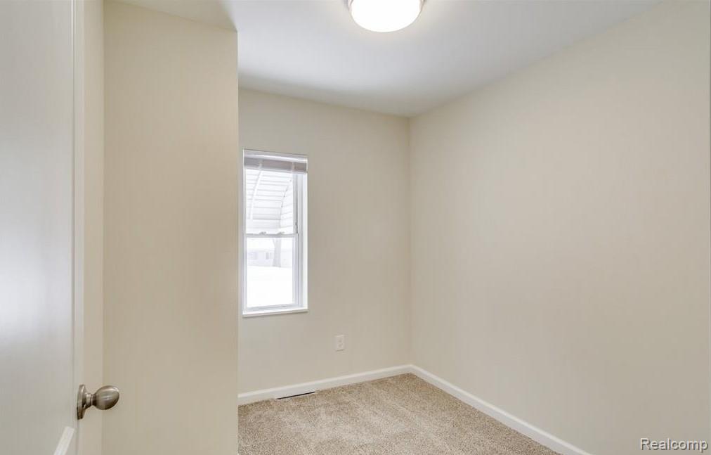 2365 Welch Road Walled Lake, MI 48390 - Photo 9 of 14 Neutral-toned walls complement the light-colored carpet flooring
