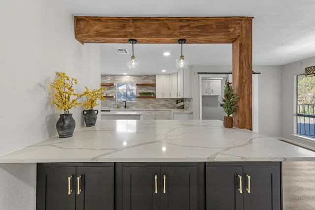 a close view of kitchen counter top space with stainless steel appliances granite countertop counter space and cabinets