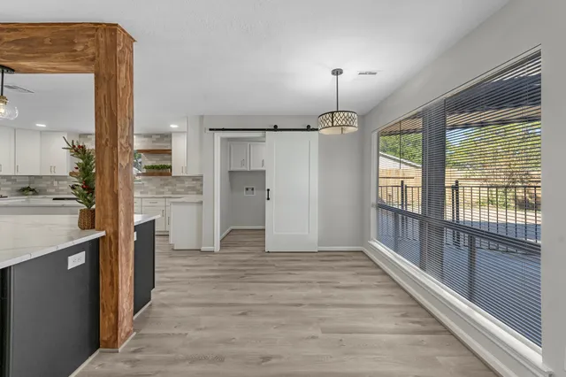 a large kitchen with a large window and stainless steel appliances