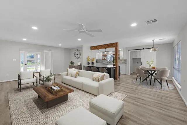 a living room with furniture and a wooden floor