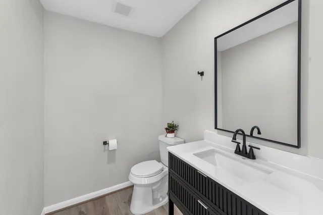 a bathroom with a sink a toilet and a mirror