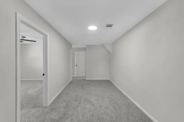 an aerial view of residential houses with outdoor space and trees