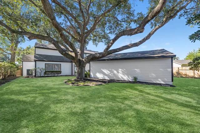 a backyard of a house with table and chairs