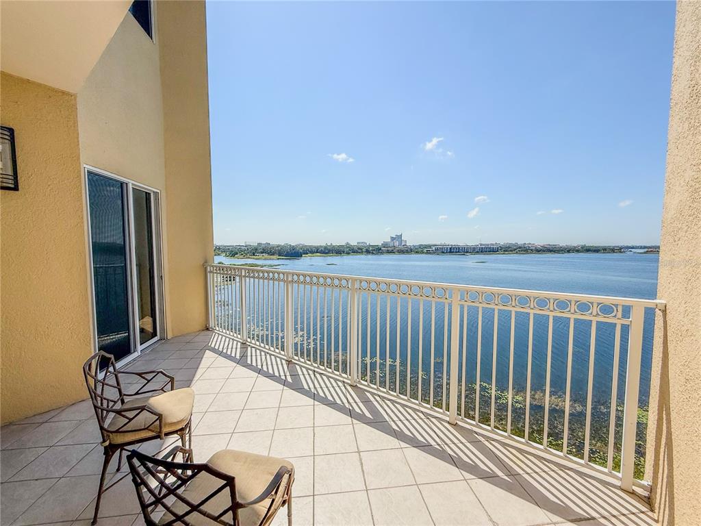 8755 The Esplanade, Unit 130 Orlando, FL 32836 - Photo 30 of 71 a view of a balcony with chair and table