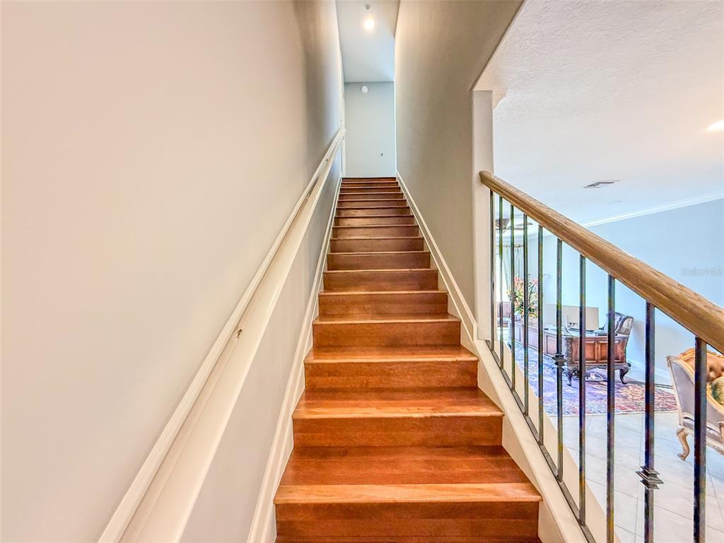 8755 The Esplanade, Unit 130 Orlando, FL 32836 - Photo 38 of 71 a view of staircase with wooden floor and white walls