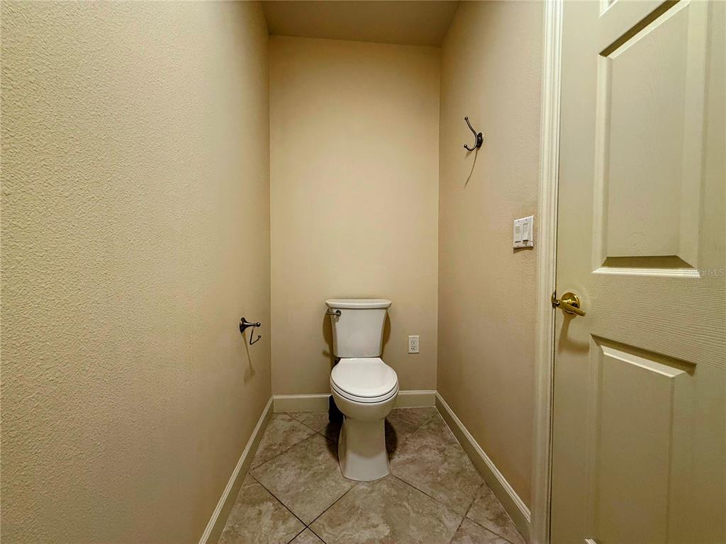 8755 The Esplanade, Unit 130 Orlando, FL 32836 - Photo 53 of 71 a white toilet sitting in a bathroom next to a sink