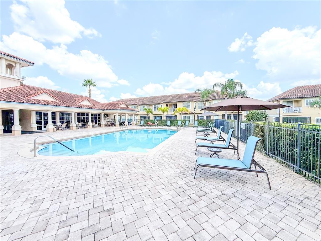 8755 The Esplanade, Unit 130 Orlando, FL 32836 - Photo 67 of 71 a view of house with swimming pool outdoor seating and barbeque oven