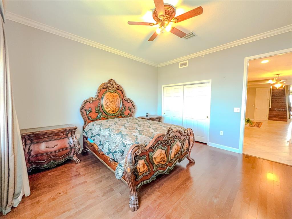 8755 The Esplanade, Unit 130 Orlando, FL 32836 - Photo 10 of 71 a bedroom with a bed and a chandelier