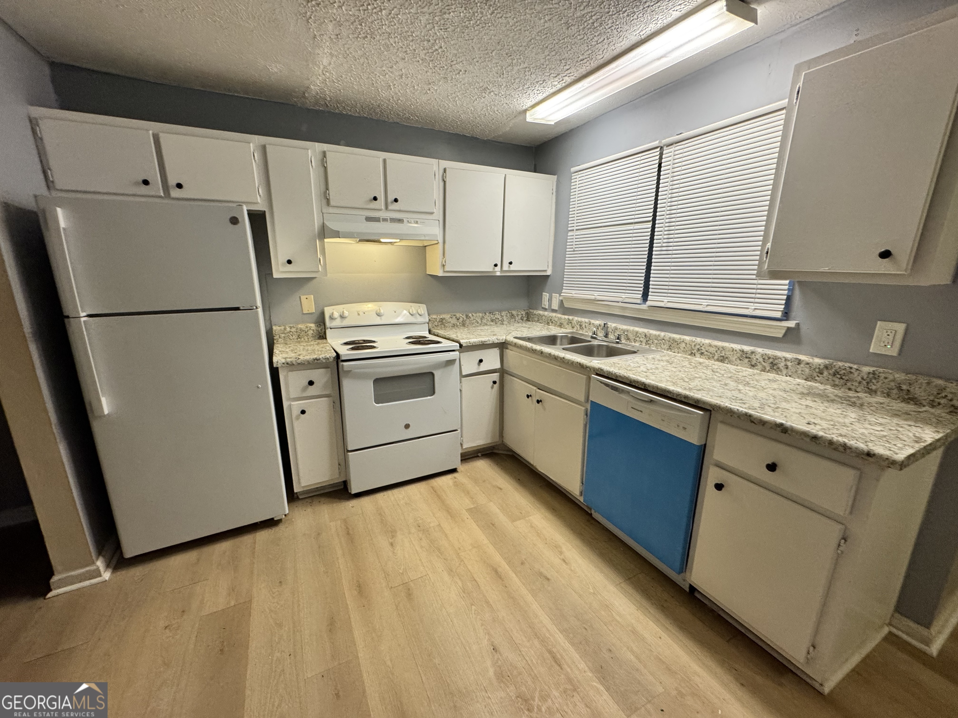 3575 Oakvale Road, Unit 911 Decatur, GA 30034 - Photo 2 of 10 a kitchen with a sink a refrigerator and cabinets