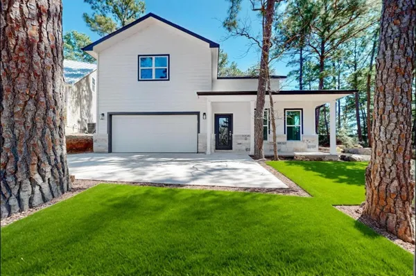 a front view of house with yard and green space